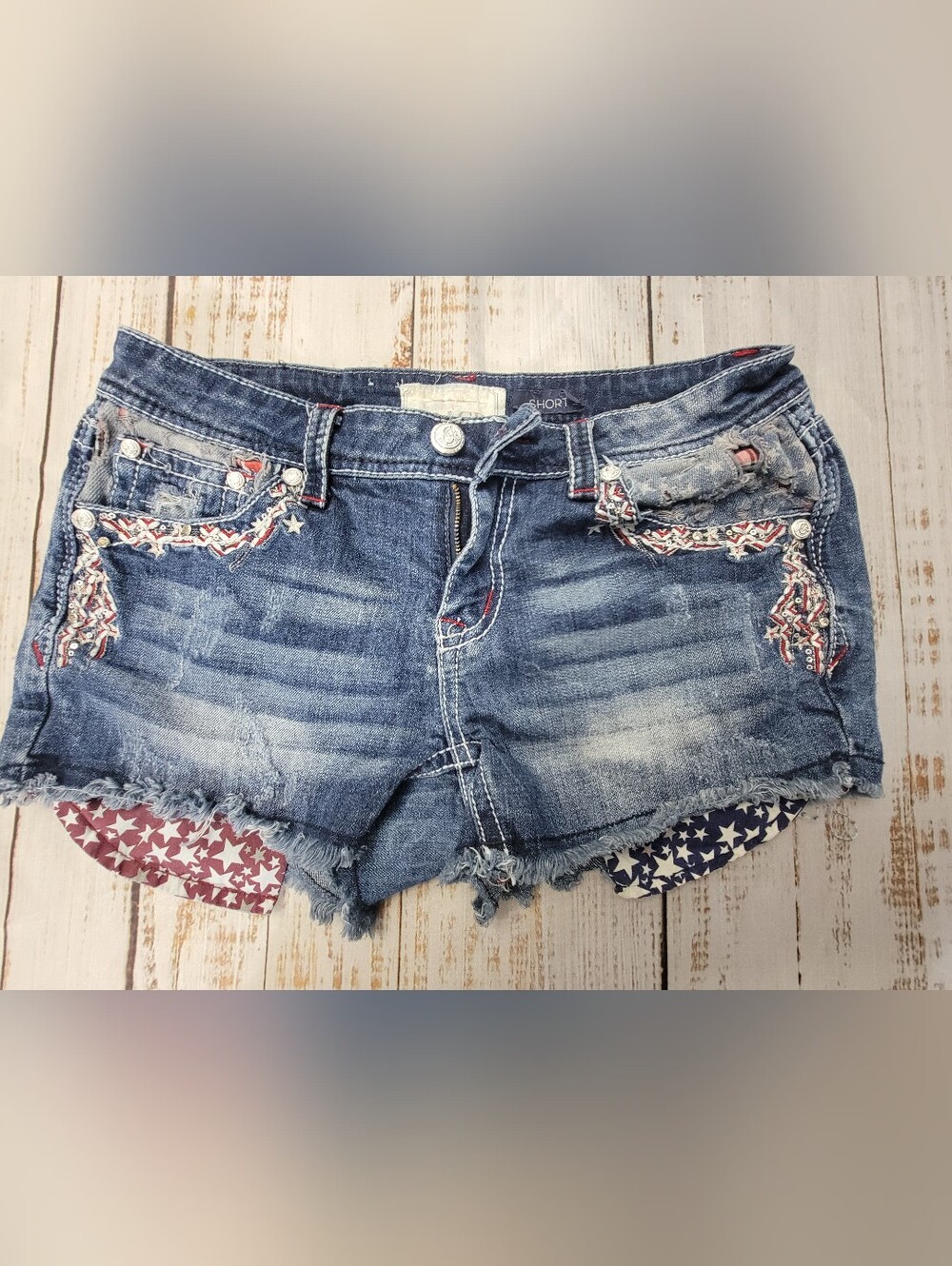 Grace in LA Blue Distressed Denim Shorts with Star-Print Lining